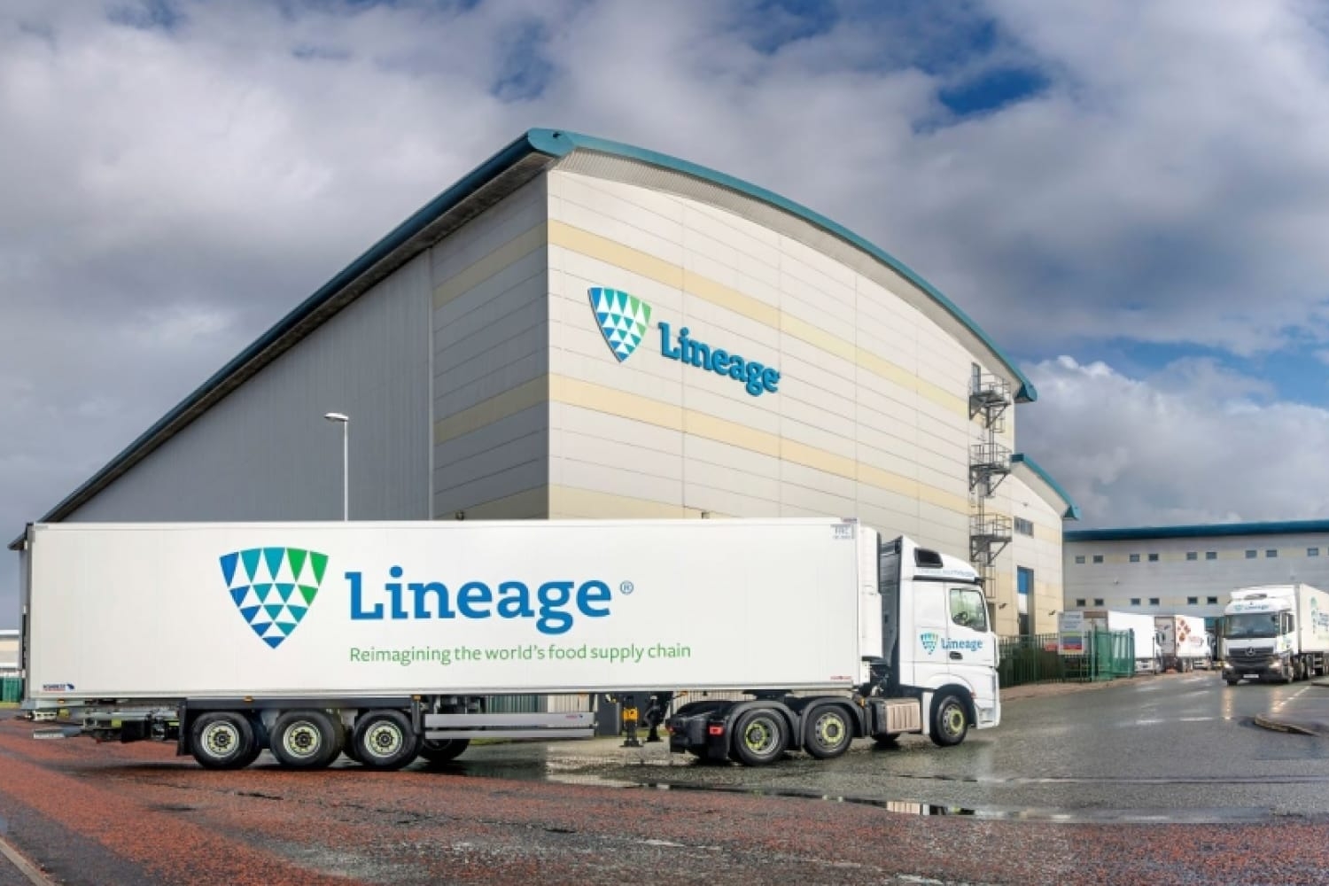 A Lineage Logistics truck, emblazoned with the company's logo, is parked in front of their facility.
Image Source: Detroit Labs